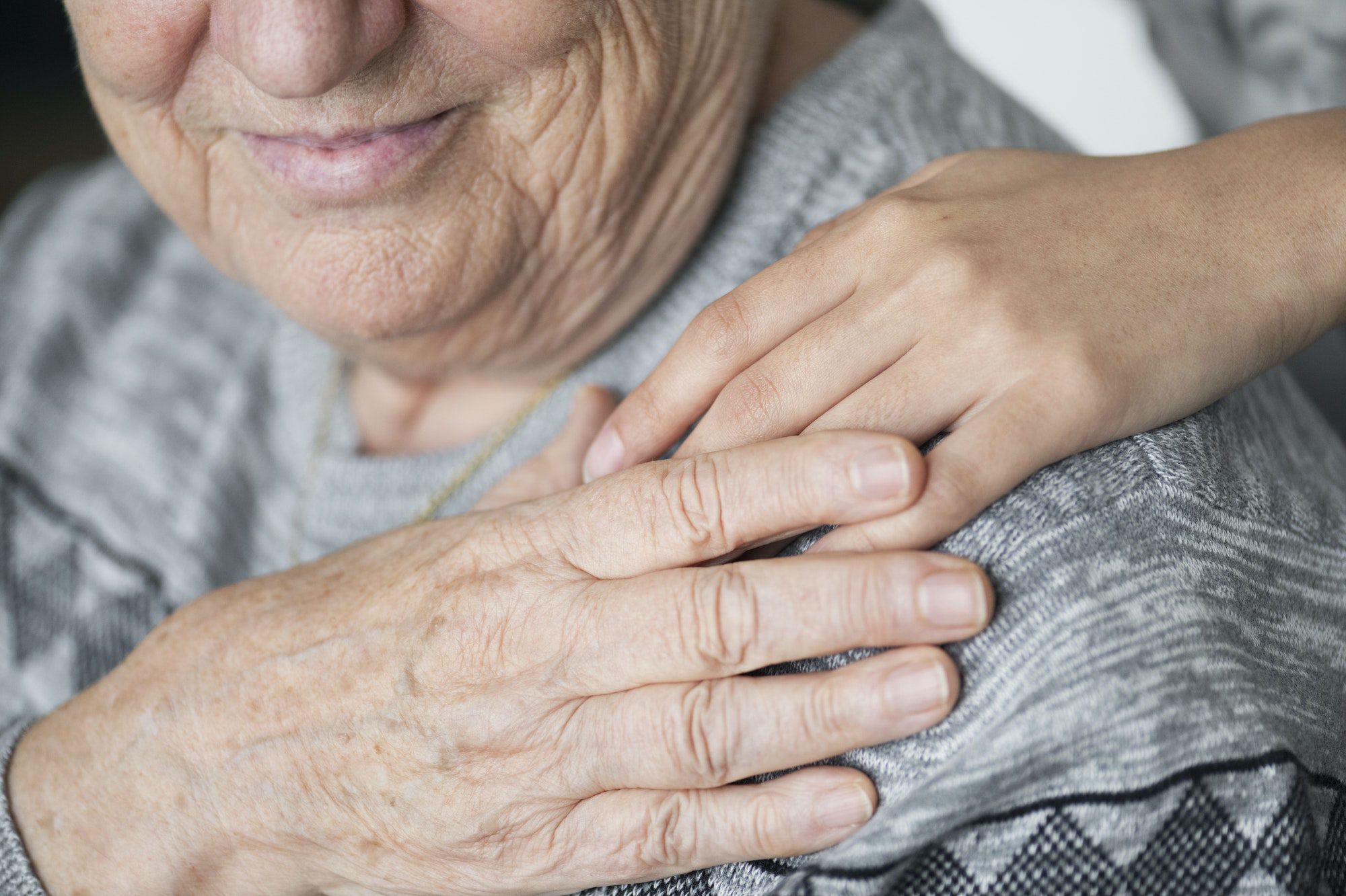 Elderly holding a hand on the shoulder happy with her Medigap Plan N