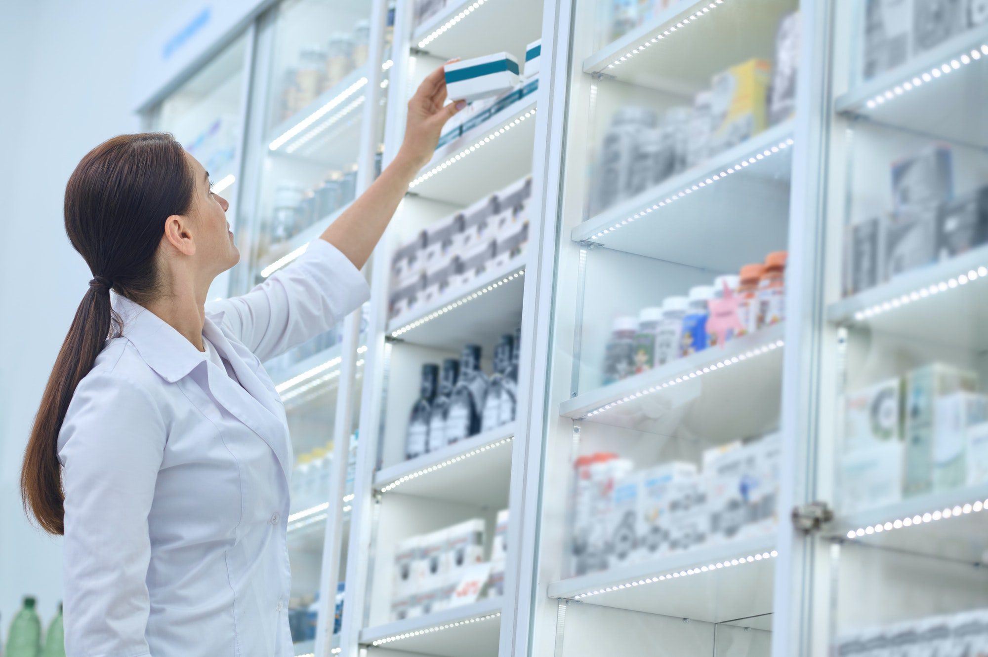 Pharmacist reaching for Medicine covered my Medicare D Phases