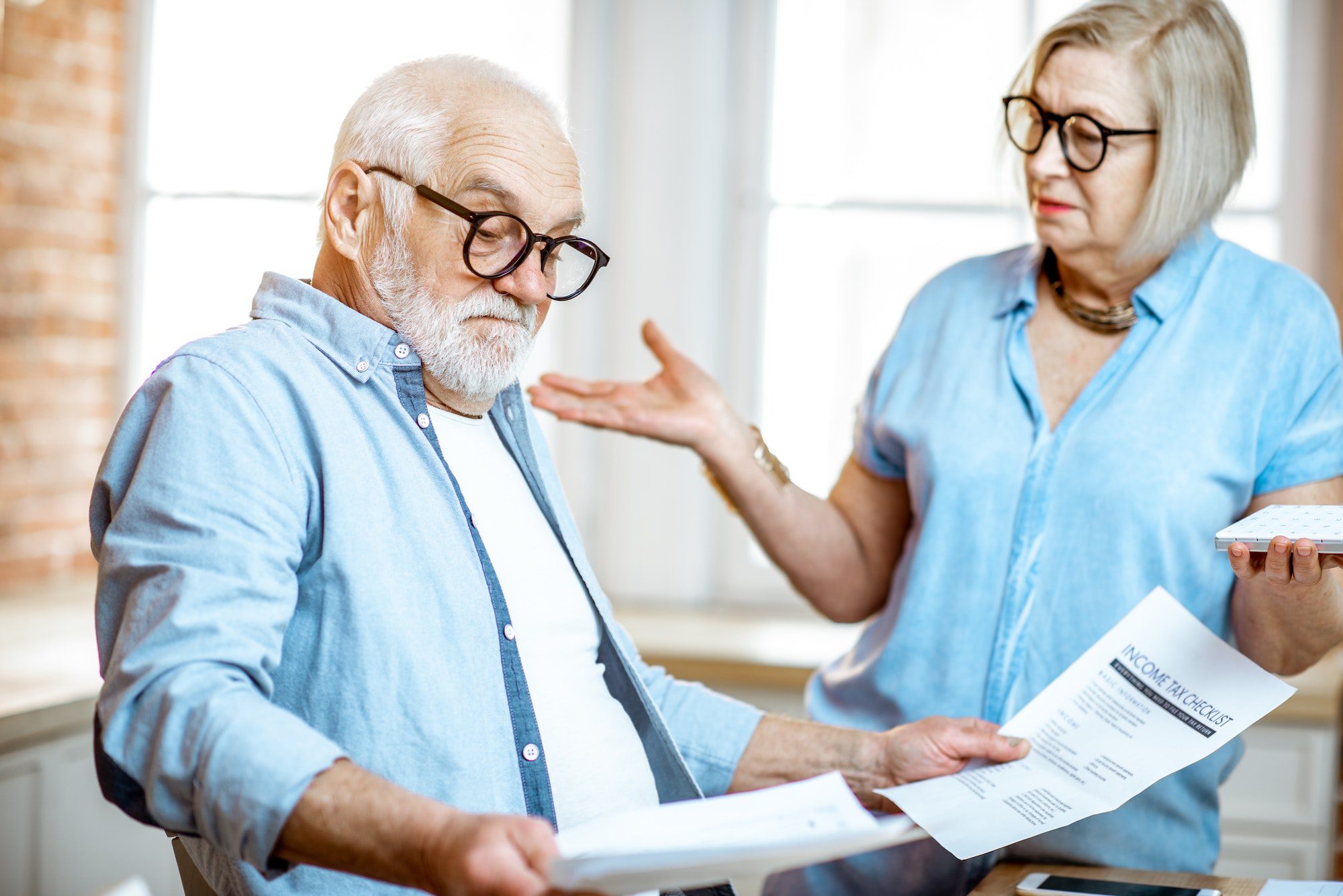 Shocked senior couple asking the question is Medicare Free.